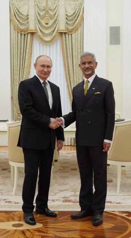 Dr. S. Jaishankar shaking hands with Russian President Vladimir Putin in a formal hall at the Kremlin