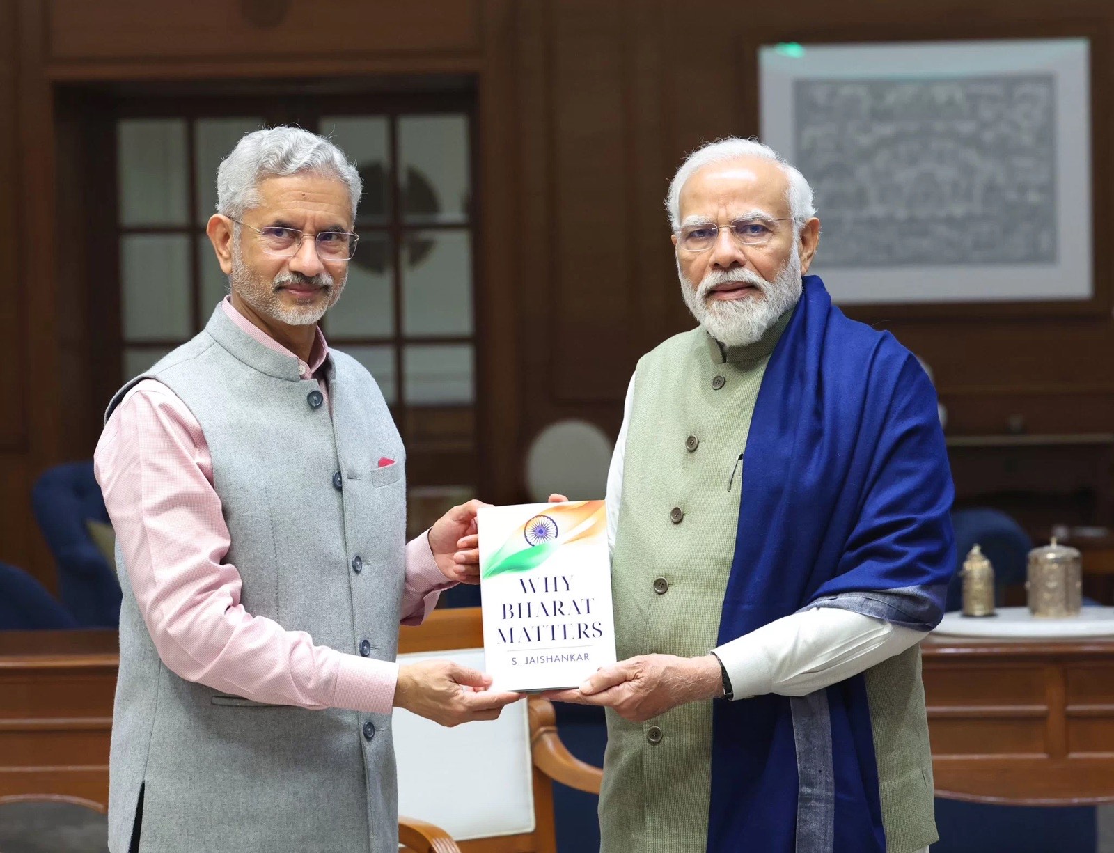 Dr. S. Jaishankar and Prime Minister Narendra Modi together holding a copy of the book Why Bharat Matters