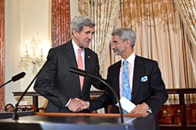 US Secretary of State John Kerry shaking hands with Indian Ambassador Dr. S. Jaishankar at a lectern in an ornate reception room