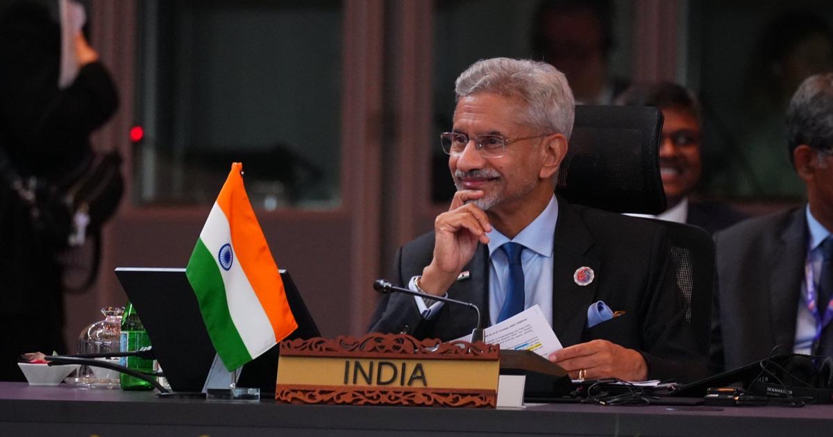 Dr. S. Jaishankar seated behind a nameplate reading India, with a small Indian flag, at a multilateral meeting