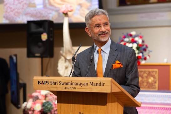 Dr. S. Jaishankar speaking at a lectern marked BAPS Shri Swaminarayan Mandir, London